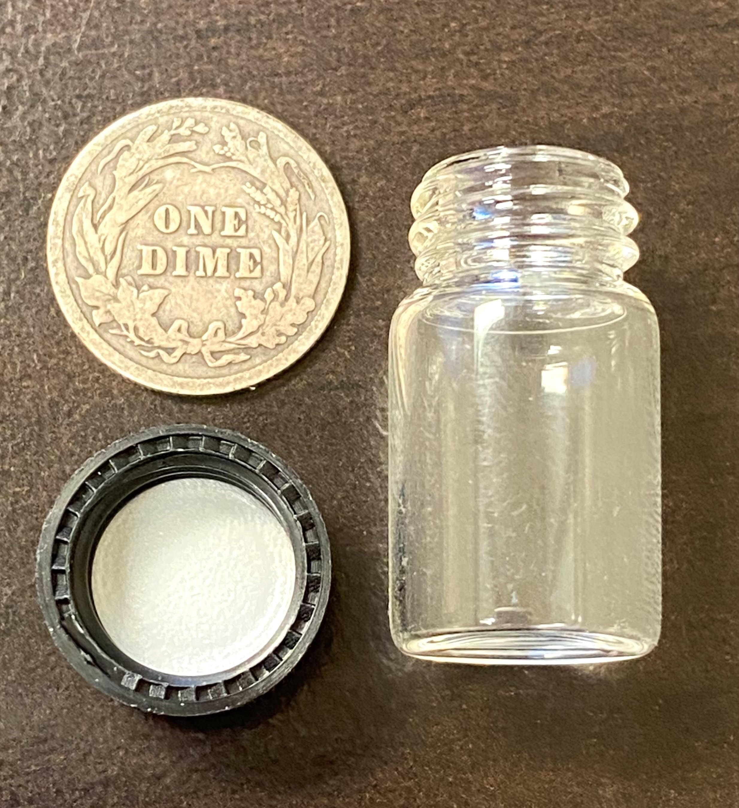 half ounce gold vial with dime for scale