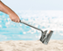 sand scoop in hand on beach