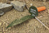 12 inch metal serrated edge metal detecting and gardening digging tool lying on ground near rock